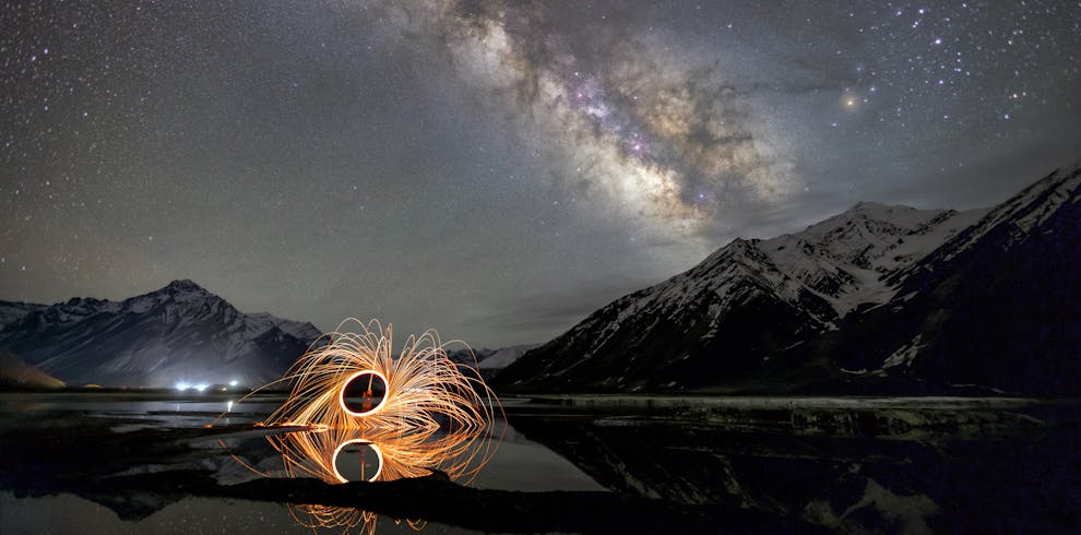 Breathtaking night sky over Zanskar with Milky Way and light art reflection.