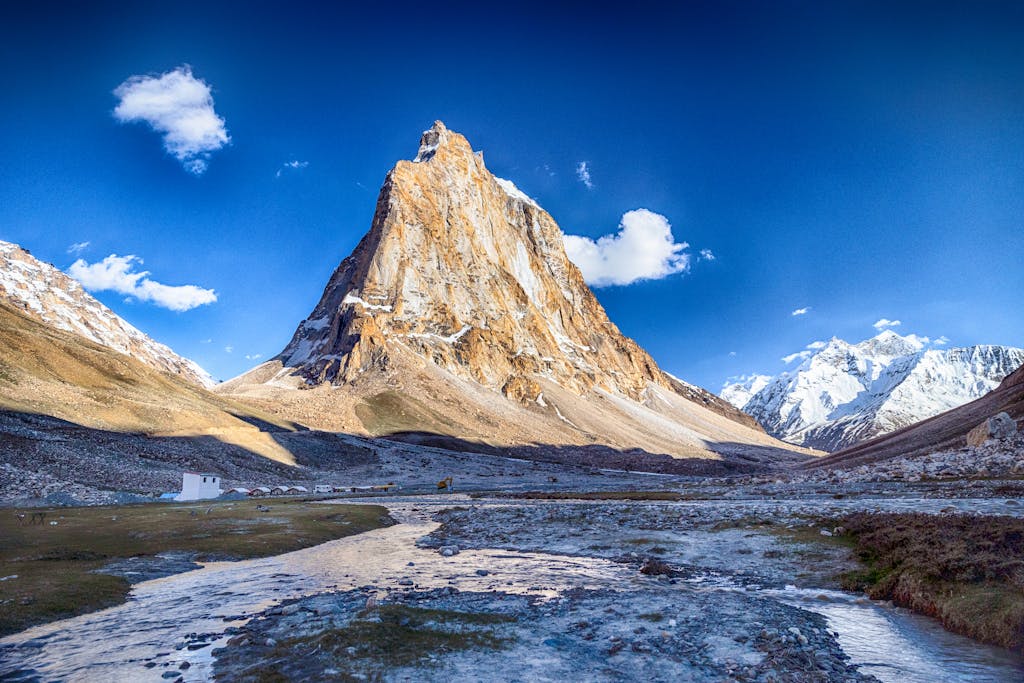 Breathtaking view of a towering mountain in the Zanskar Range with clear blue skies.