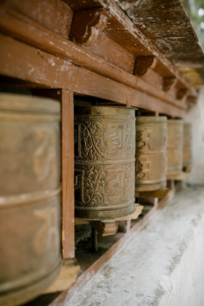 Rustic Buddhist prayer wheels at a monastery in Leh, India.